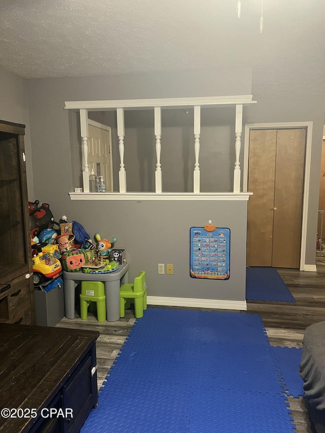 game room featuring a textured ceiling