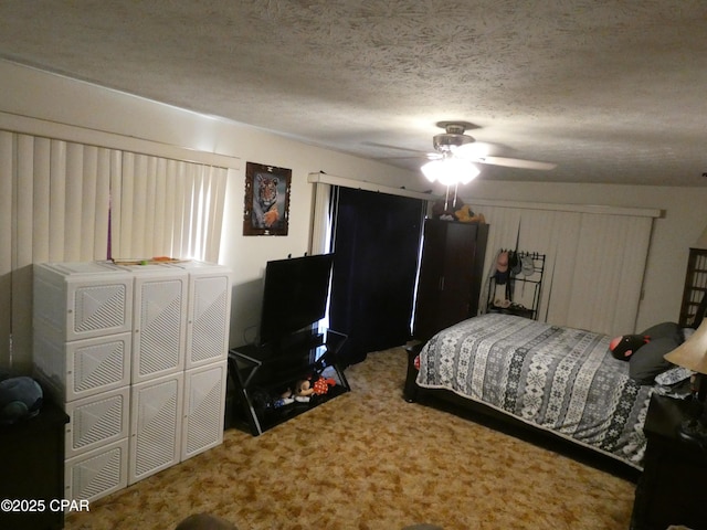 carpeted bedroom with ceiling fan and a textured ceiling