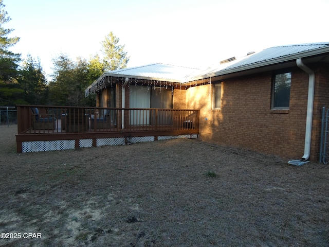 rear view of house featuring a deck