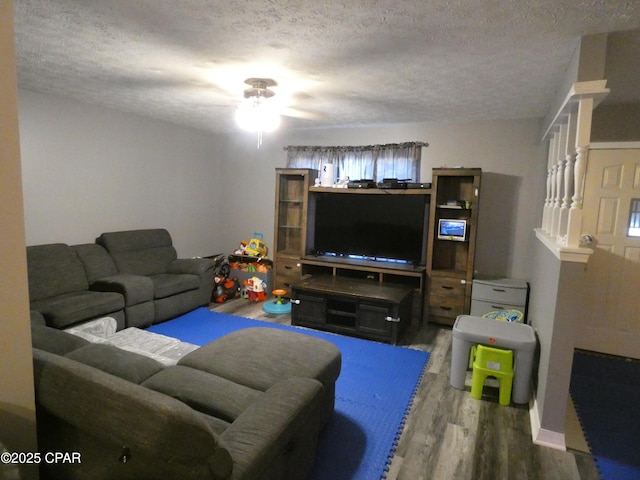 living room featuring hardwood / wood-style flooring and a textured ceiling