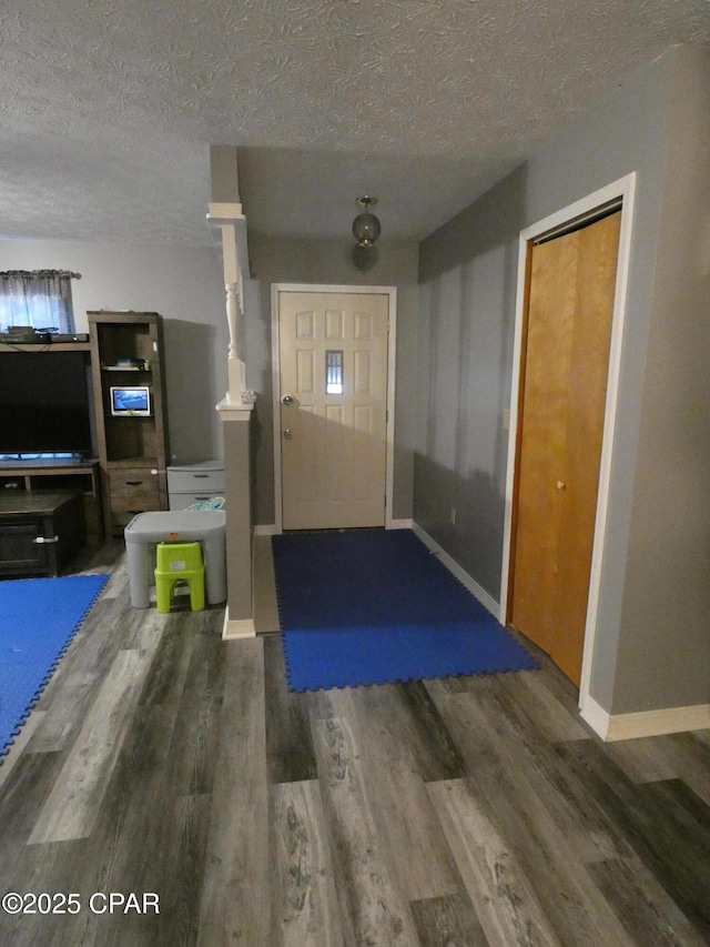 entrance foyer featuring dark wood-type flooring and a textured ceiling