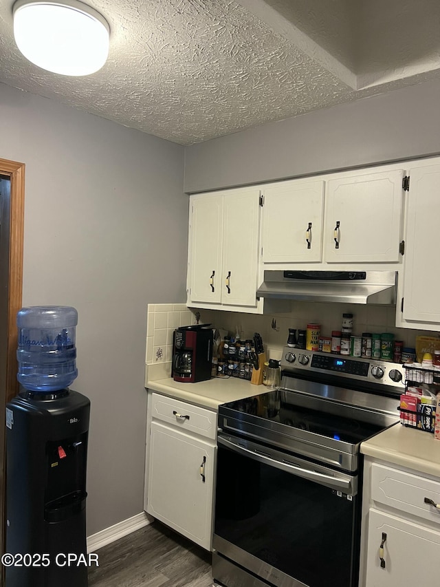 kitchen with tasteful backsplash, a textured ceiling, electric range, dark hardwood / wood-style flooring, and white cabinets