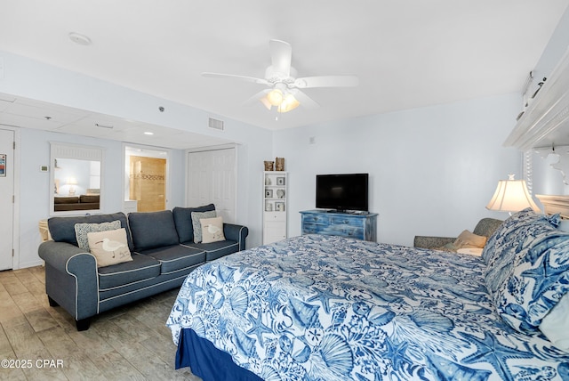 bedroom with wood-type flooring, ceiling fan, and a closet