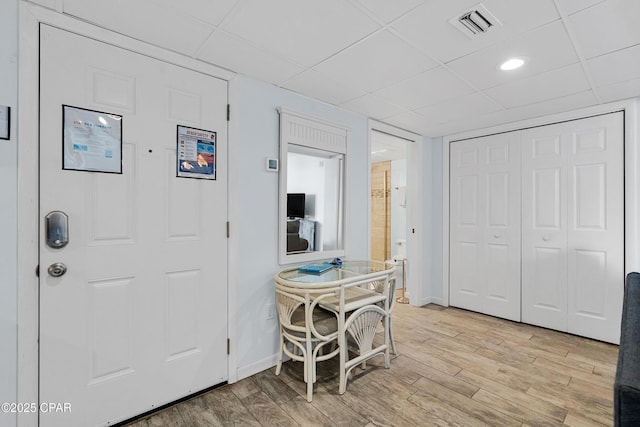 foyer with a drop ceiling