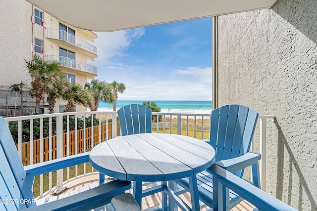 balcony with a beach view and a water view