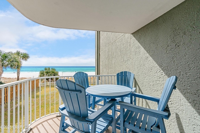 balcony with a water view and a beach view