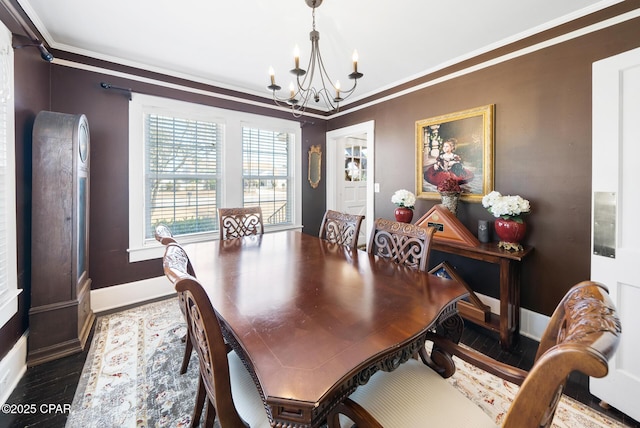 dining area with ornamental molding, hardwood / wood-style floors, and a notable chandelier