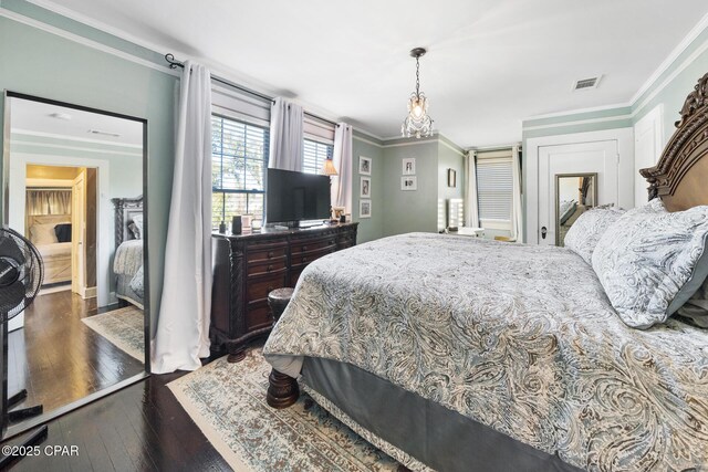 bedroom with dark hardwood / wood-style flooring and crown molding