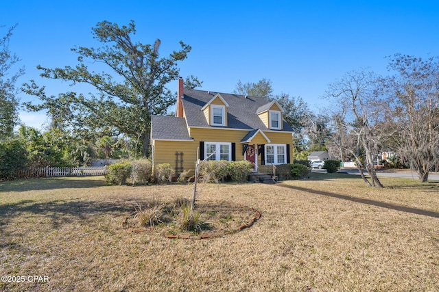 cape cod home with a front lawn