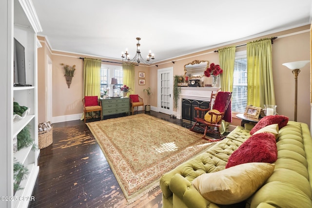 living room featuring hardwood / wood-style flooring, crown molding, and an inviting chandelier