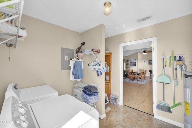 laundry area with light tile patterned flooring, ceiling fan, electric panel, and washer and dryer