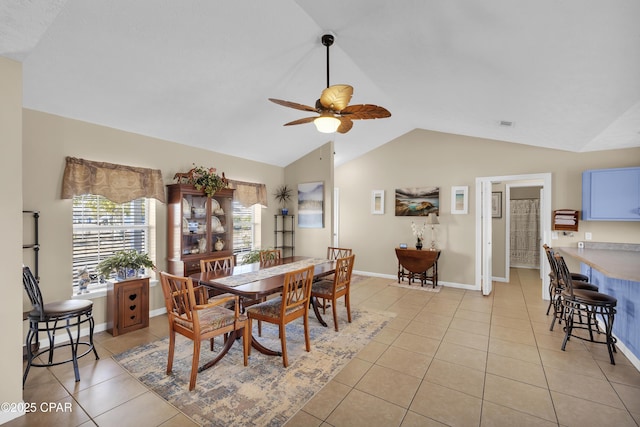 dining area featuring lofted ceiling, light tile patterned floors, and ceiling fan