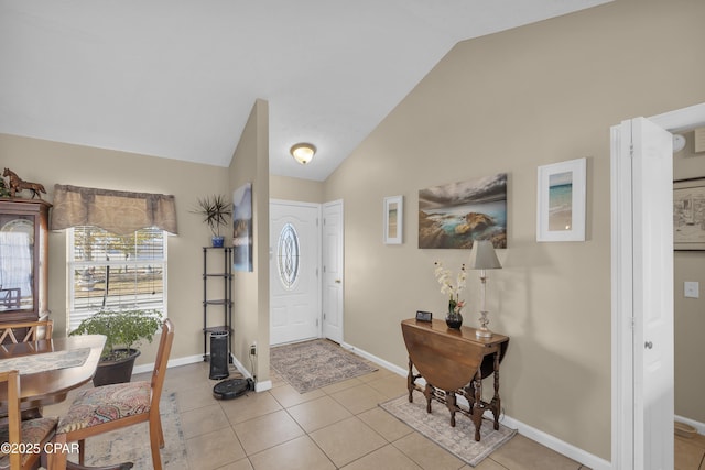 foyer with lofted ceiling and light tile patterned floors