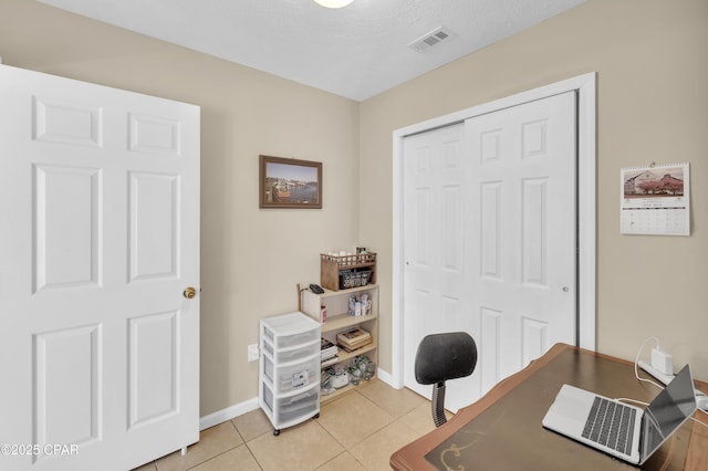 tiled office with a textured ceiling