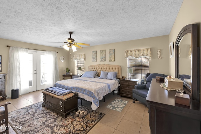 tiled bedroom featuring french doors, ceiling fan, multiple windows, and access to outside