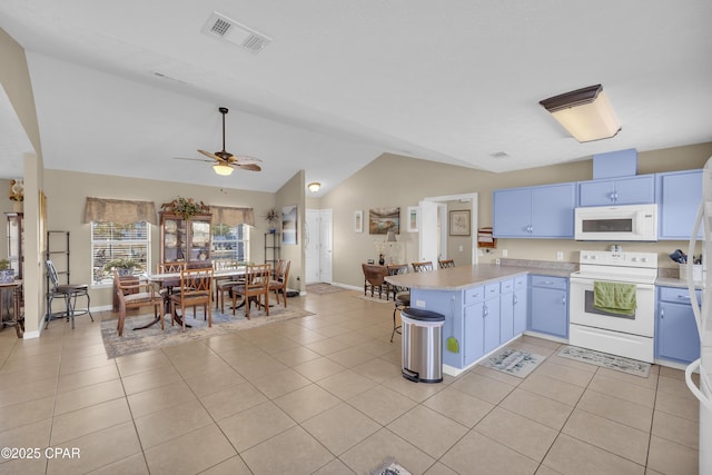 kitchen with blue cabinetry, white appliances, kitchen peninsula, and light tile patterned floors