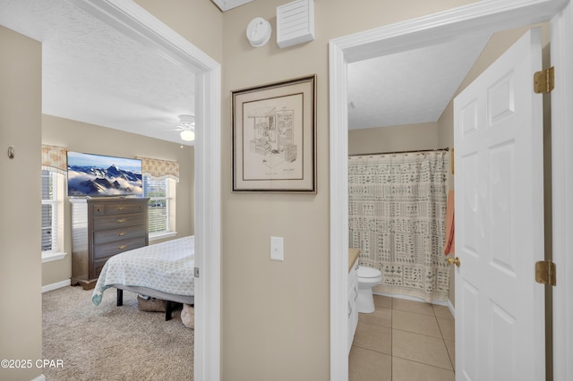 full bathroom featuring ceiling fan, tile patterned flooring, vanity, a textured ceiling, and toilet