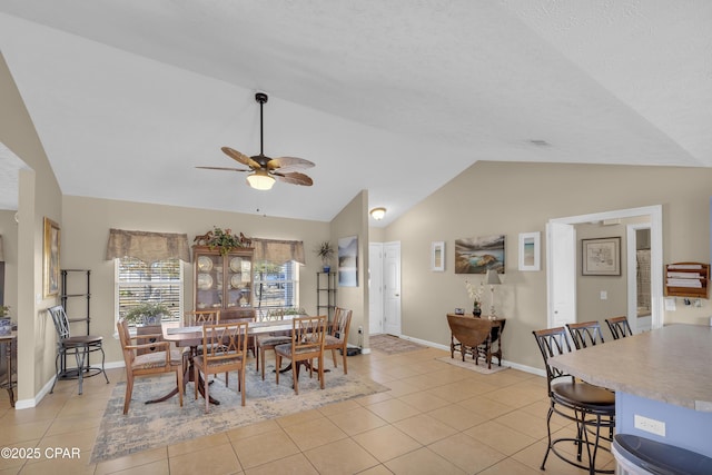 dining room featuring light tile patterned flooring, ceiling fan, and lofted ceiling