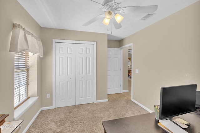 office with ceiling fan and light carpet