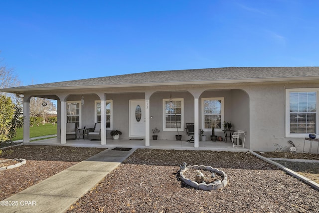 view of exterior entry featuring covered porch