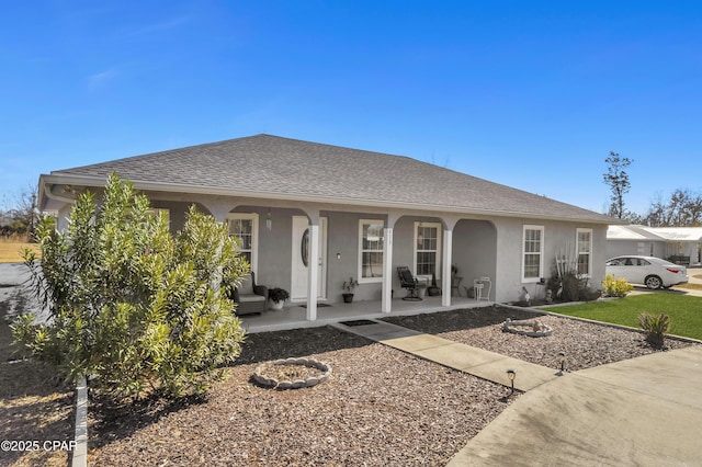 single story home featuring covered porch