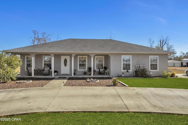 view of front of property with a front yard and covered porch