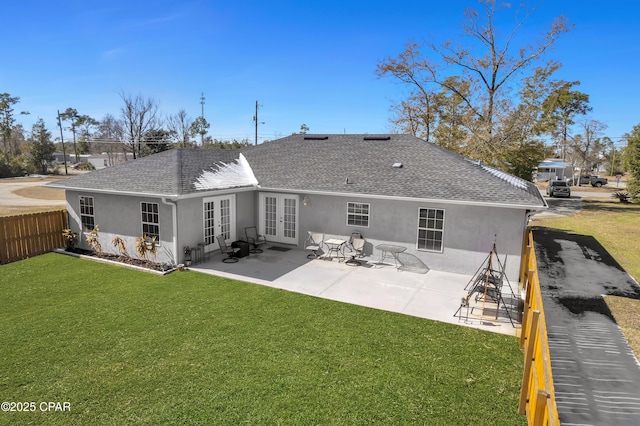 back of house with a patio area, french doors, and a lawn