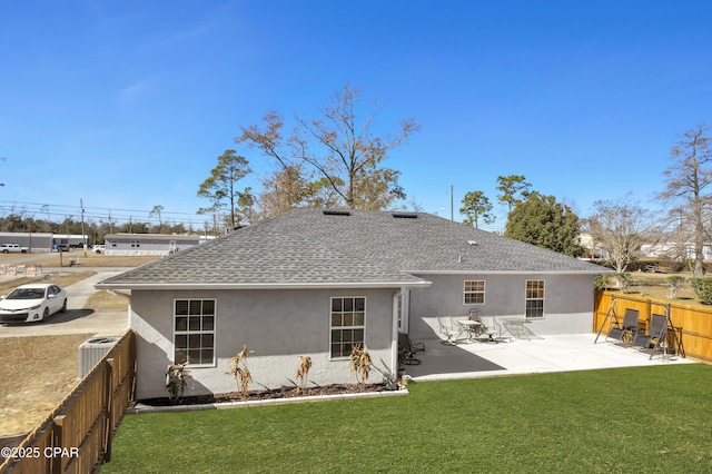 back of property featuring cooling unit, a patio area, and a lawn