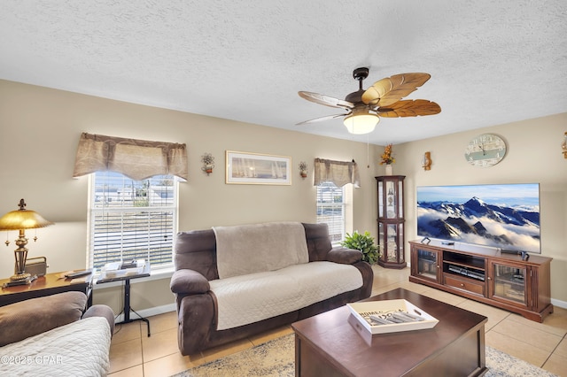 tiled living room featuring ceiling fan, a healthy amount of sunlight, and a textured ceiling