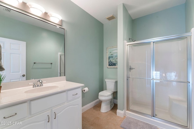 bathroom featuring vanity, tile patterned floors, toilet, and walk in shower