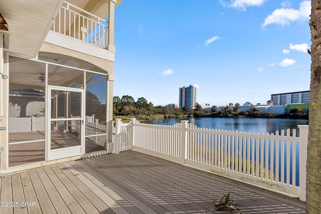 deck with a water view and a sunroom