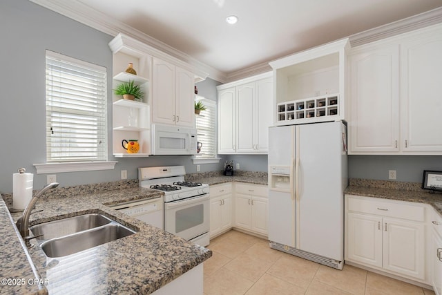 kitchen with white cabinetry, white appliances, dark stone counters, and sink