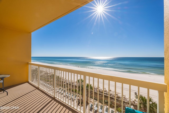 balcony featuring a beach view and a water view