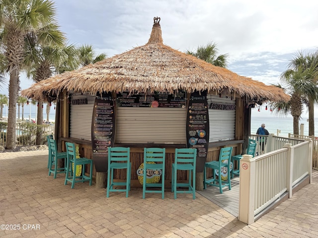 view of patio featuring a bar and a water view