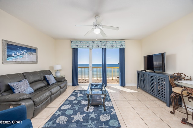 tiled living room with ceiling fan