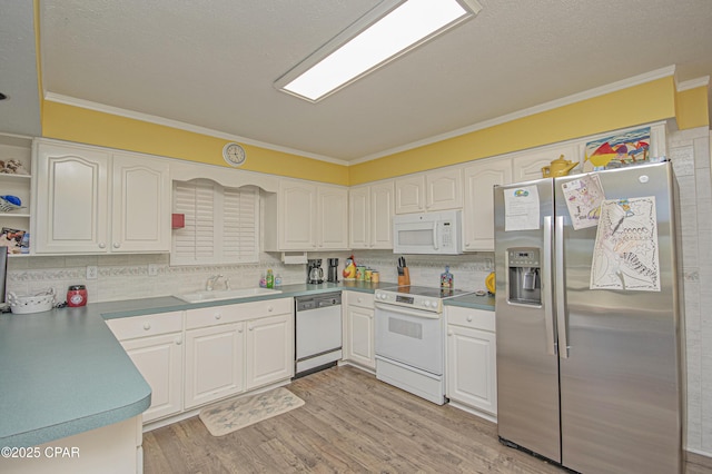 kitchen with white cabinetry, ornamental molding, sink, and white appliances