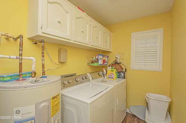 washroom featuring hardwood / wood-style flooring, cabinets, separate washer and dryer, and water heater