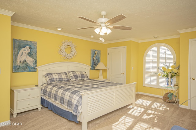 bedroom featuring ceiling fan, ornamental molding, light carpet, and a textured ceiling