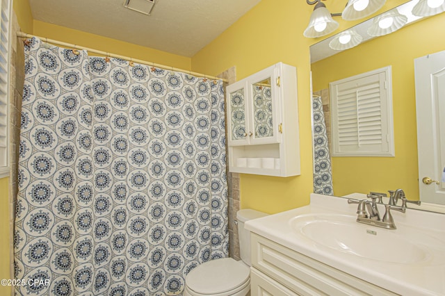 bathroom with a shower with curtain, vanity, toilet, and a textured ceiling