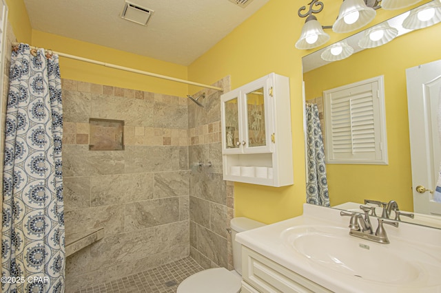 bathroom featuring vanity, toilet, a shower with shower curtain, and a textured ceiling