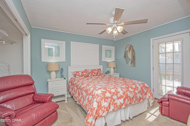 carpeted bedroom featuring a textured ceiling and ceiling fan