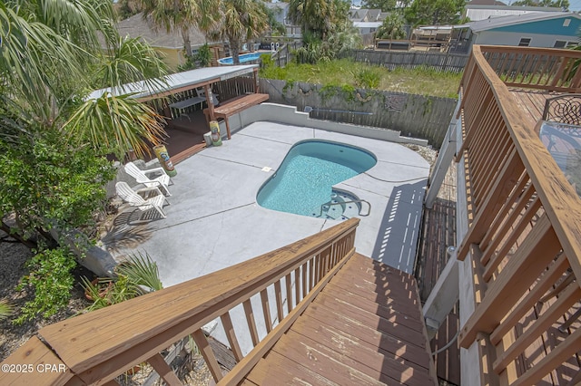 view of swimming pool with a deck and a patio area