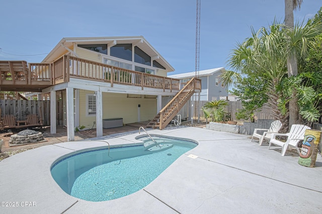 view of swimming pool with an outdoor fire pit, a patio, and a deck