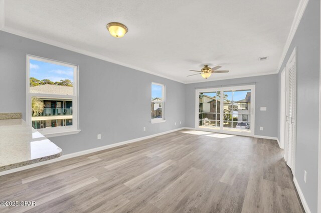 spare room with ornamental molding, ceiling fan, and light hardwood / wood-style floors