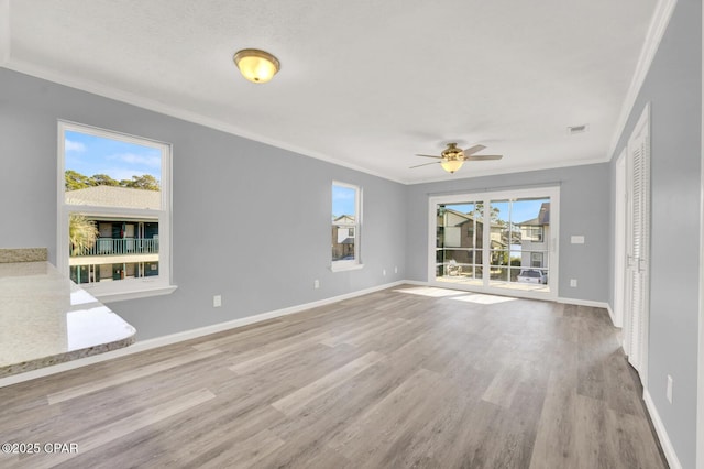 unfurnished room with crown molding, a textured ceiling, ceiling fan, and light hardwood / wood-style floors