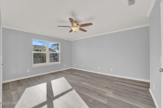 spare room featuring ornamental molding, light hardwood / wood-style floors, and ceiling fan