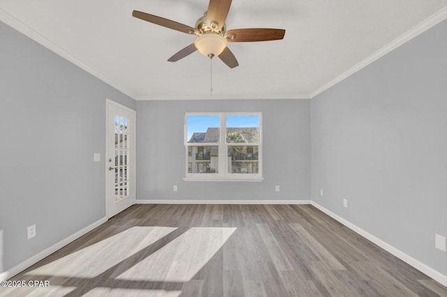 empty room featuring ceiling fan, ornamental molding, and light wood-type flooring