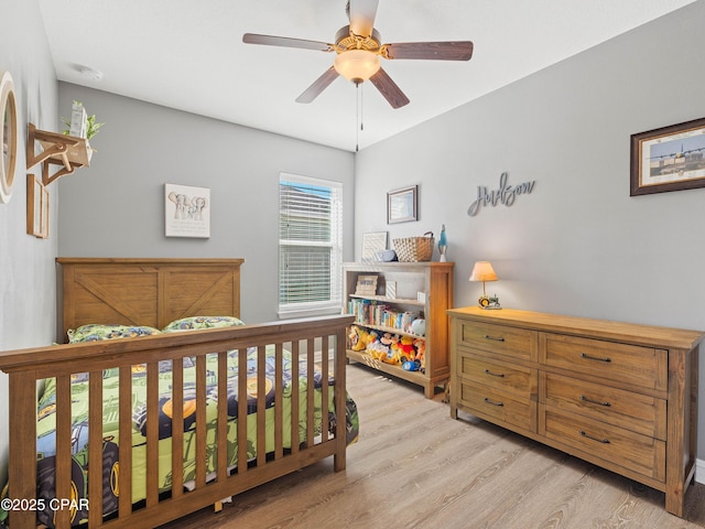bedroom featuring light wood-type flooring and ceiling fan