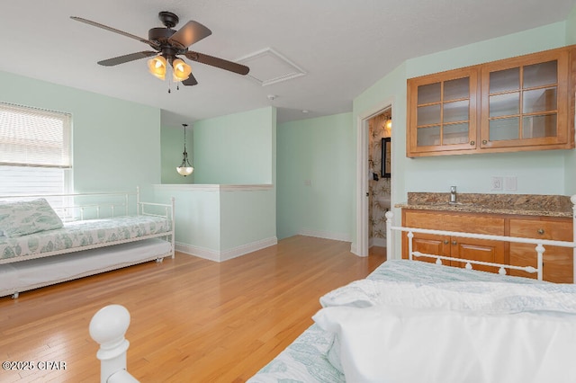 bedroom featuring baseboards, light wood-style floors, and ceiling fan