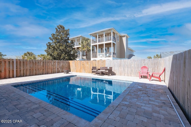 view of swimming pool with a fenced in pool, a patio, and a fenced backyard